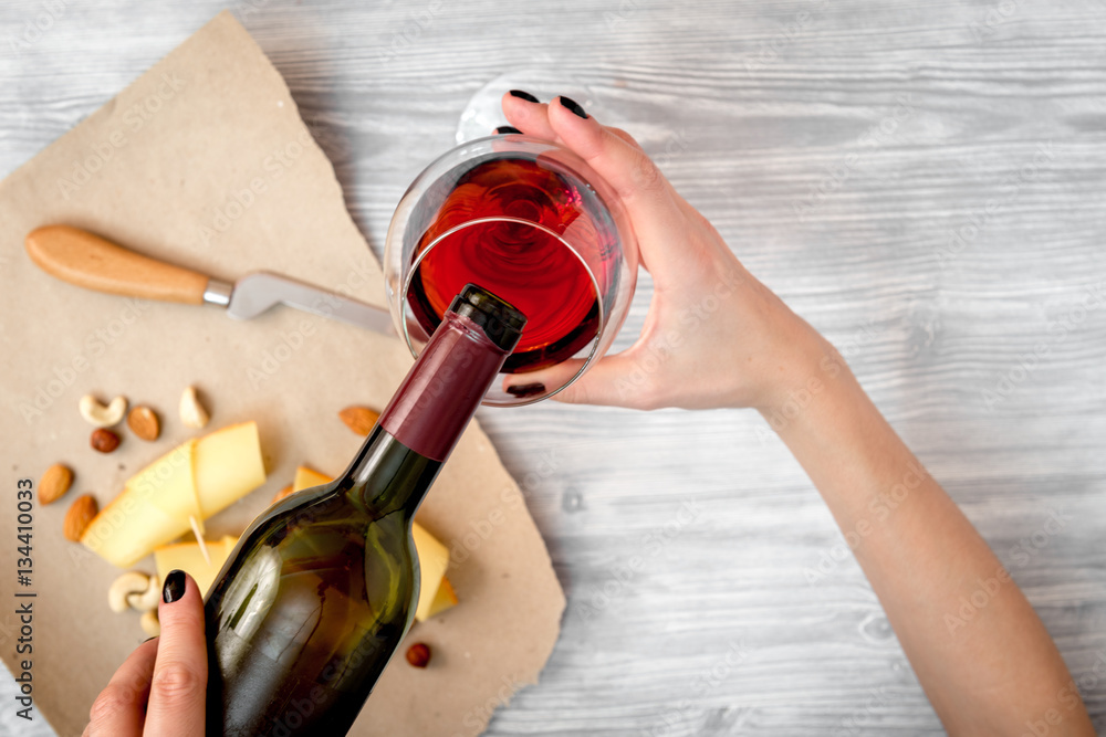 red wine with cheese on wooden background top view