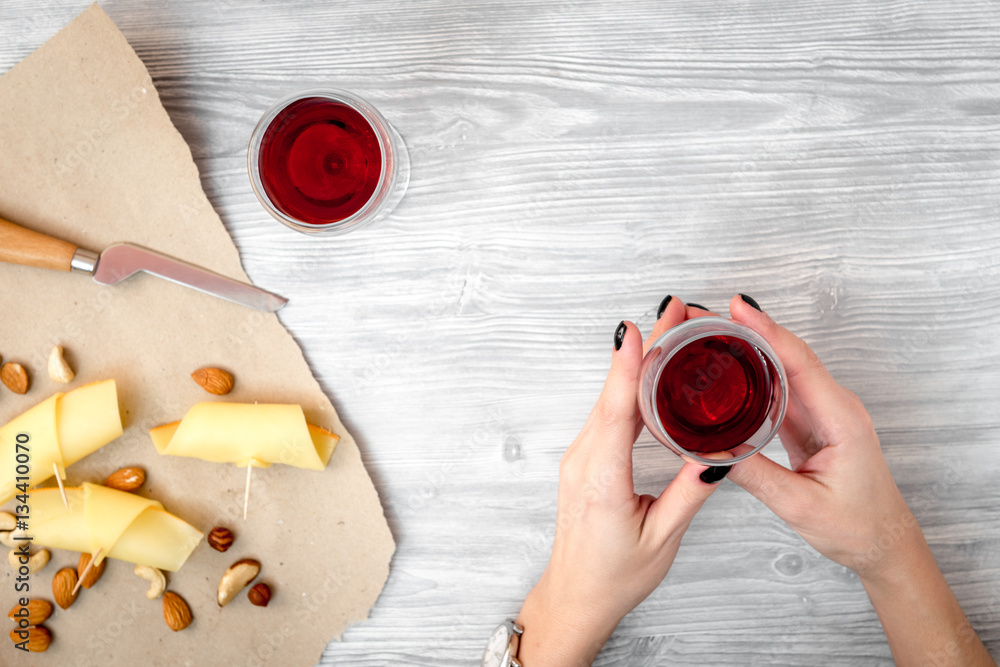 red wine with cheese on wooden background top view