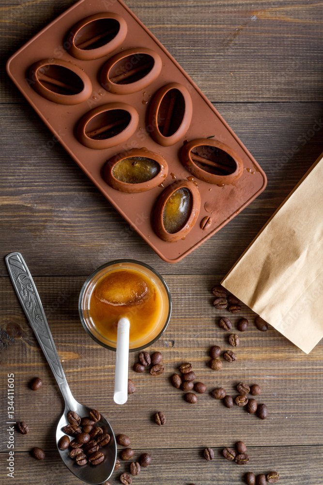 coffee with ice in glass on wooden background top view