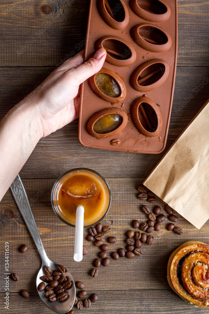 coffee with ice in glass on wooden background top view