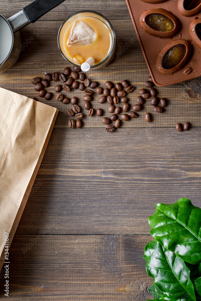 coffee with ice in glass on wooden background top view