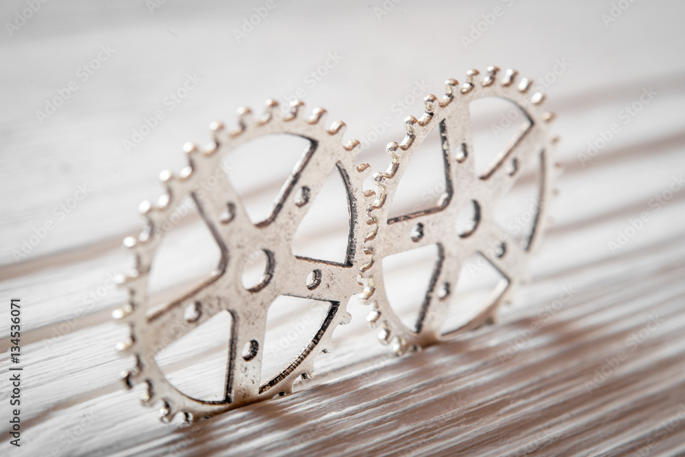 concept hour metal gears on wooden background top view