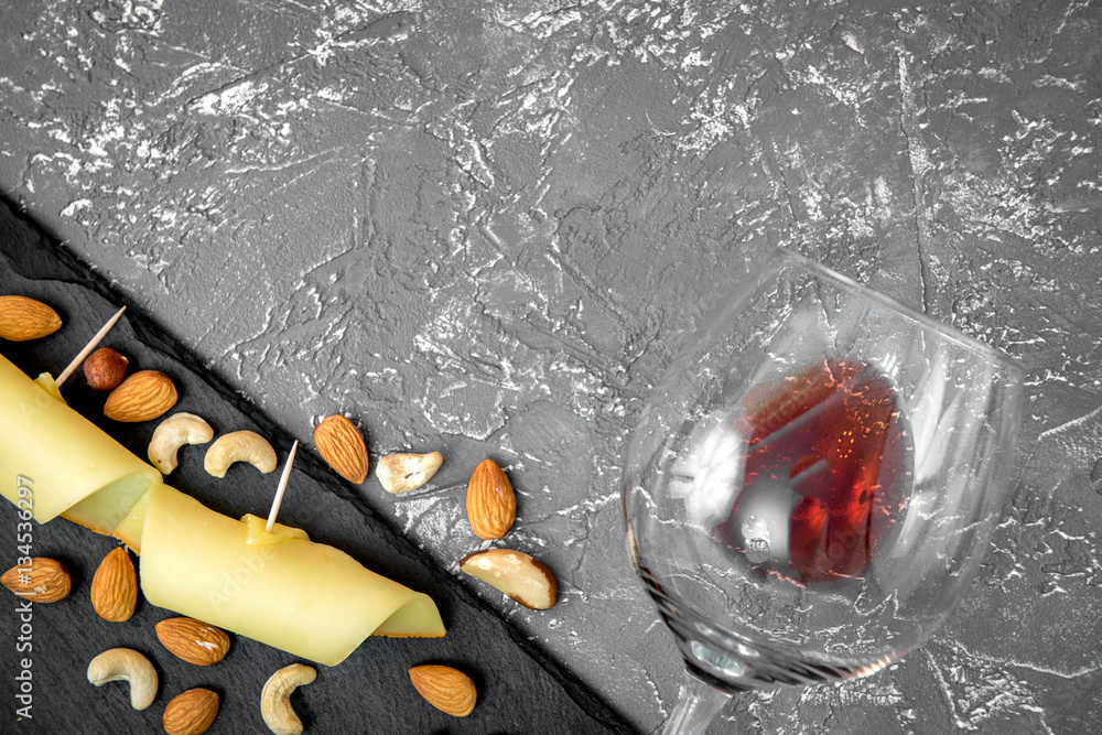 red wine with cheese on dark background top view