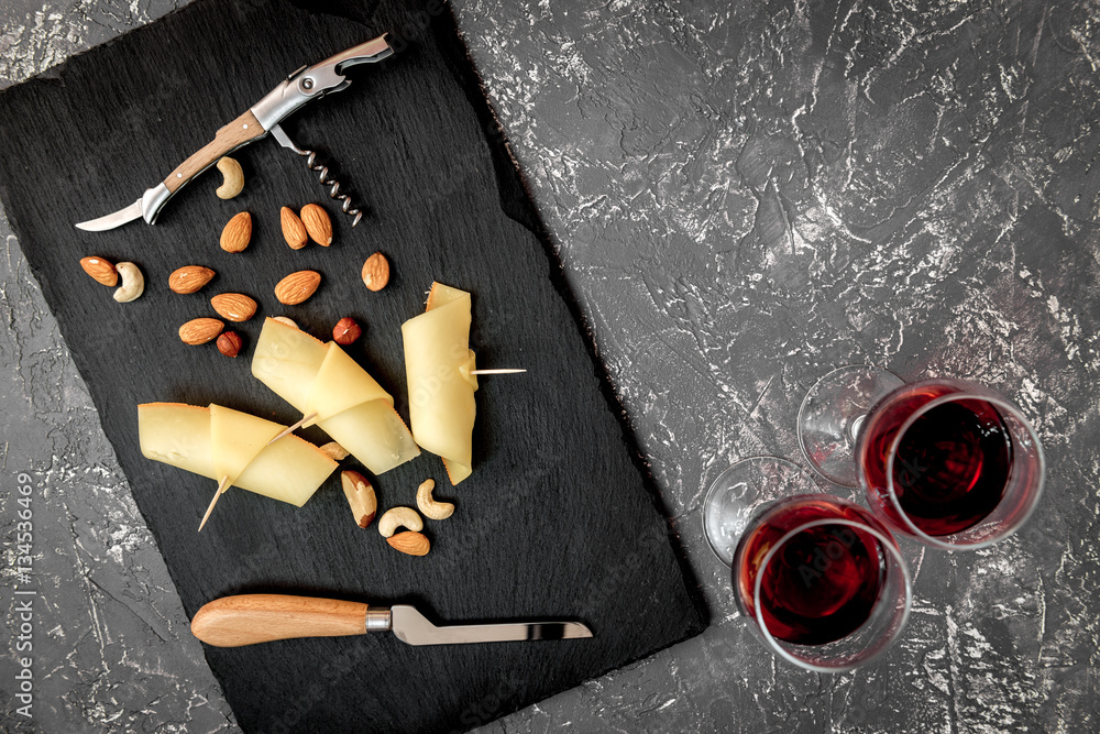 red wine with cheese on dark background top view