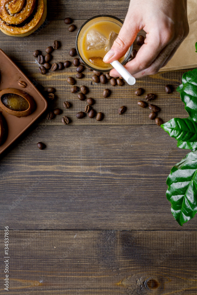 coffee with ice in glass on wooden background top view