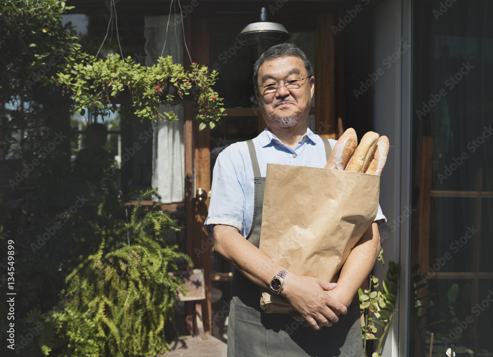 Old asian guy with baked goods paper bag