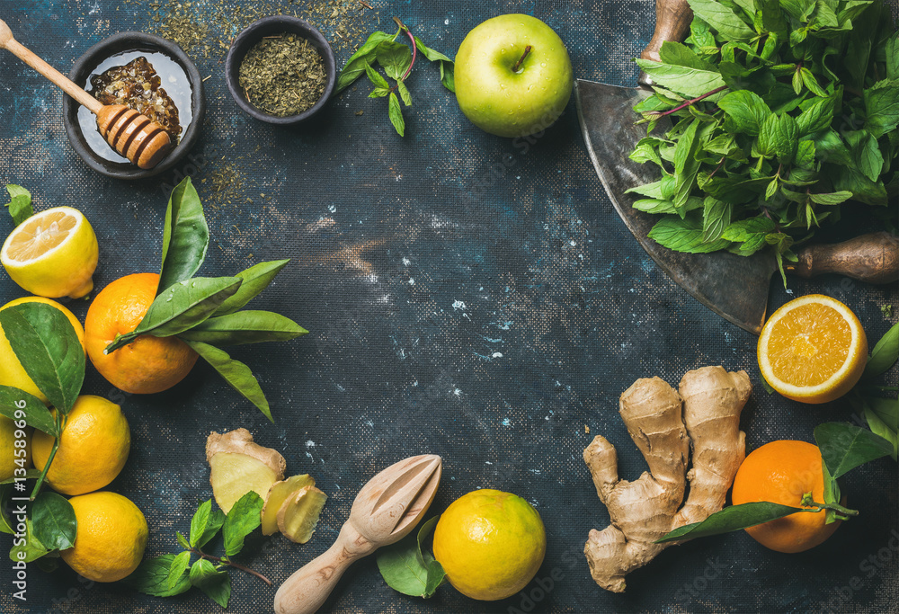 Ingredients for making natural hot drink. Oranges, fresh mint, lemons, ginger, honey, apple and spic