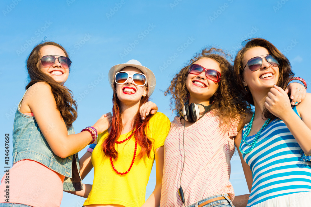 group of young people wearing sunglasses and hat