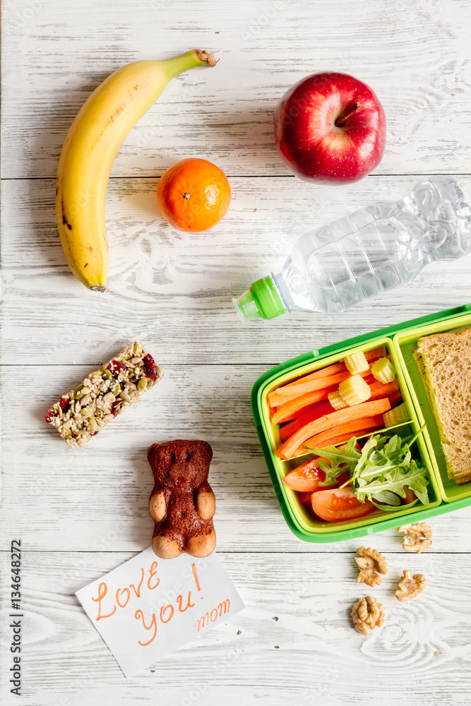 kid menu lunchbox for school top view on wooden background