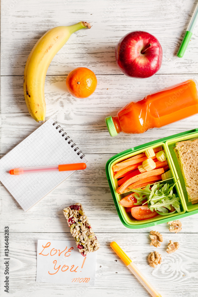 kid menu lunchbox for school top view on wooden background