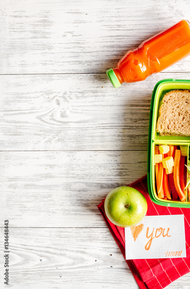 kid menu lunchbox for school top view on wooden background