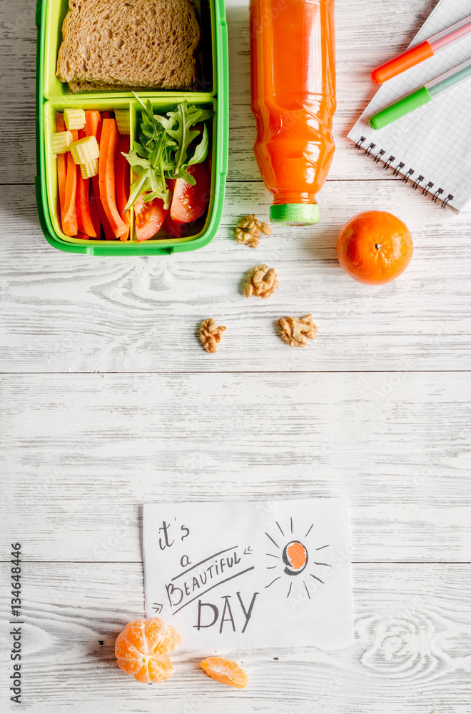 kid menu lunchbox for school top view on wooden background