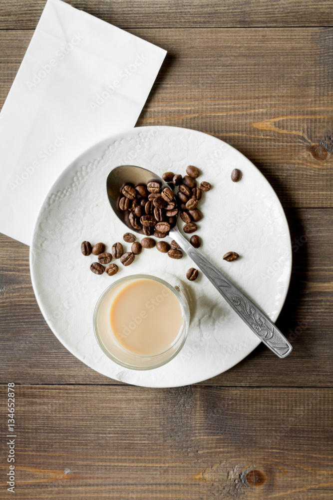 coffee with ice in glass on wooden background top view