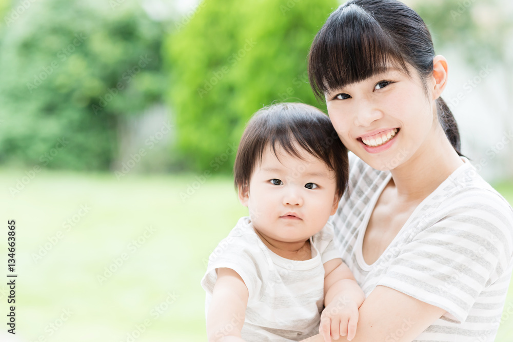 portrait of asian mother and baby in the park