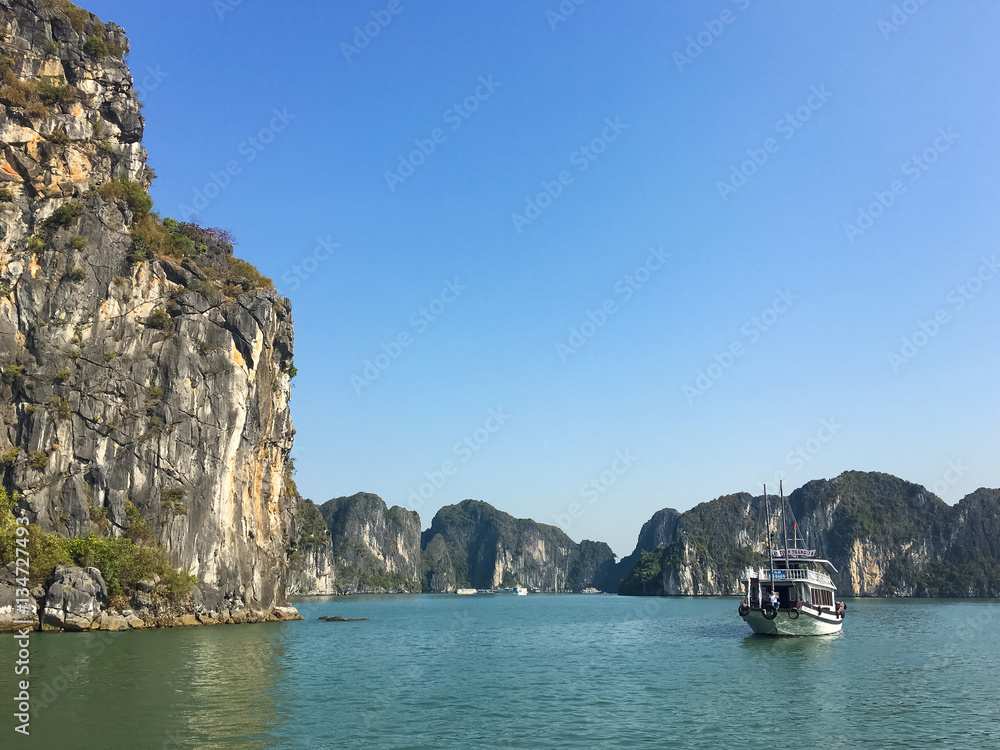 Sightseeing boat and limestone mountain at Halong bay , Vietnam