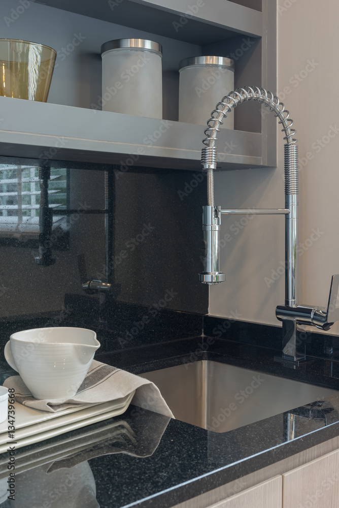 modern kitchen room with sink on top granite counter