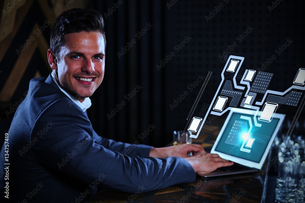 Composite image of portrait of man using laptop in counter 3d