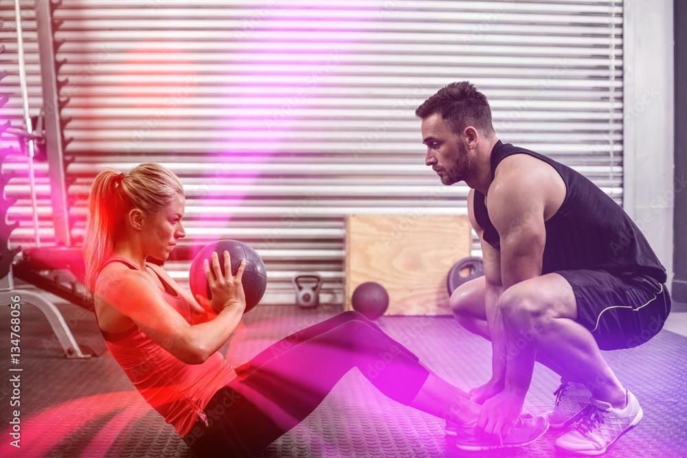 Fit couple doing abdominal ball exercise