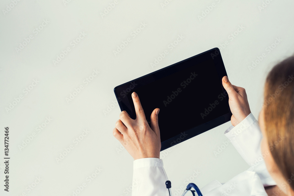 Close of female doctor hands working with tablet pc computer