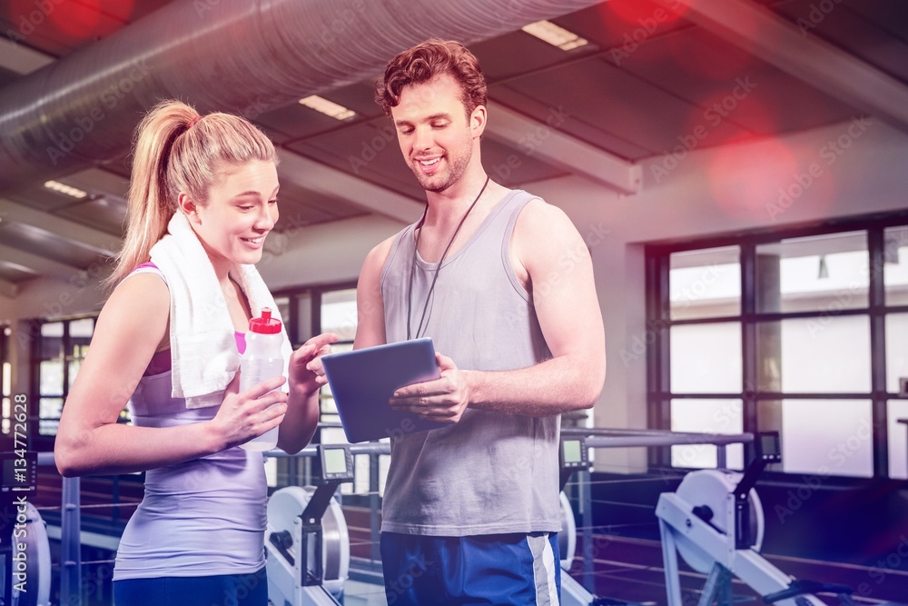 Woman talking to trainer after workout