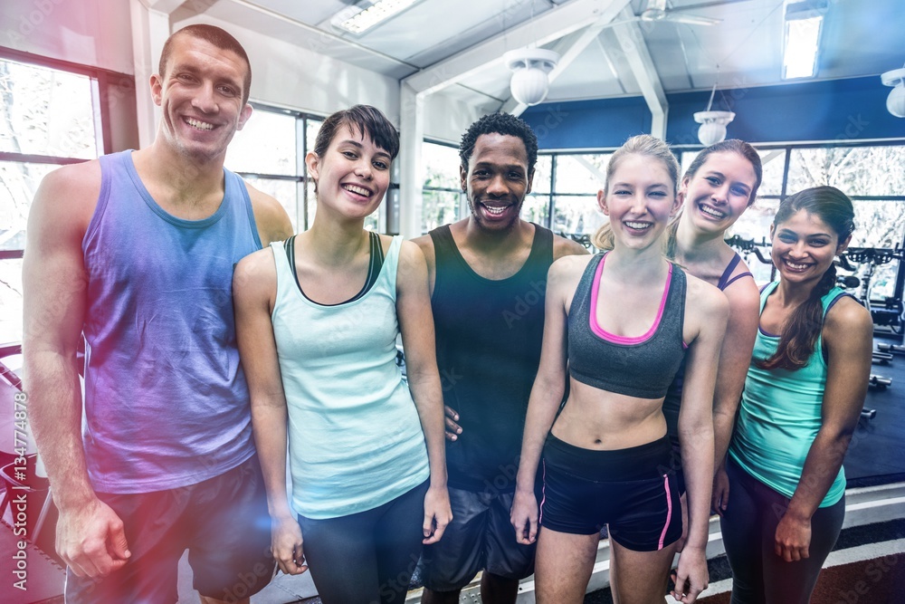 Smiling fitness class posing together