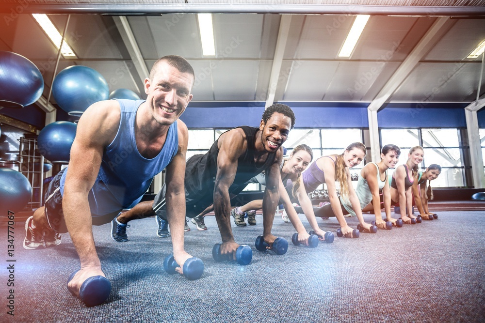 Fit people working out in fitness class