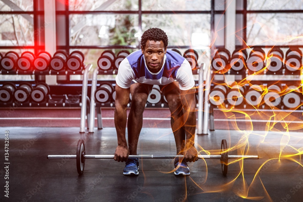 Concentrated muscular man lifting barebell