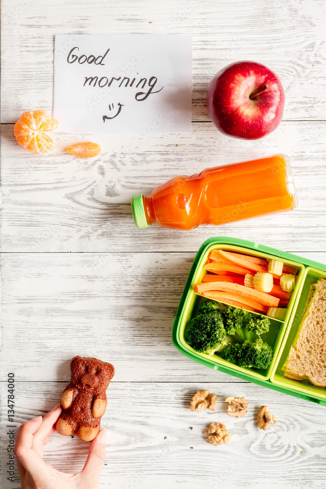 kid menu lunchbox for school top view on wooden background