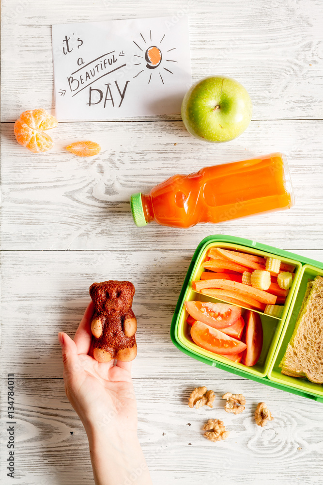 kid menu lunchbox for school top view on wooden background