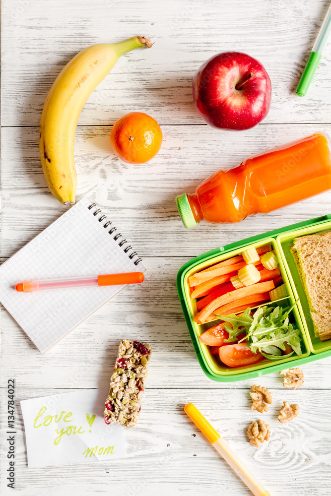 kid menu lunchbox for school top view on wooden background