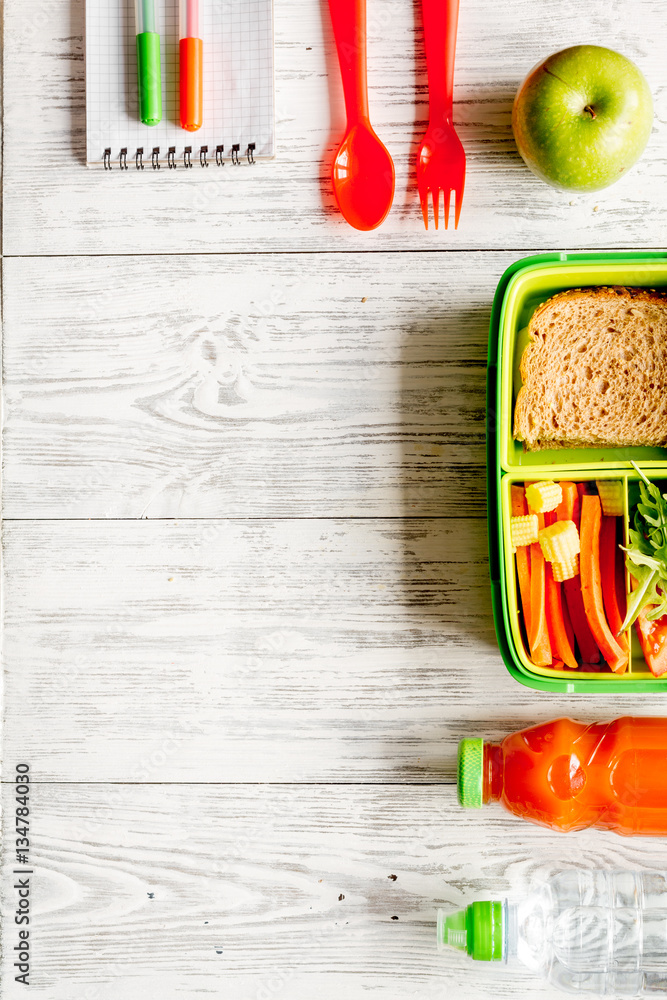 kid menu lunchbox for school top view on wooden background