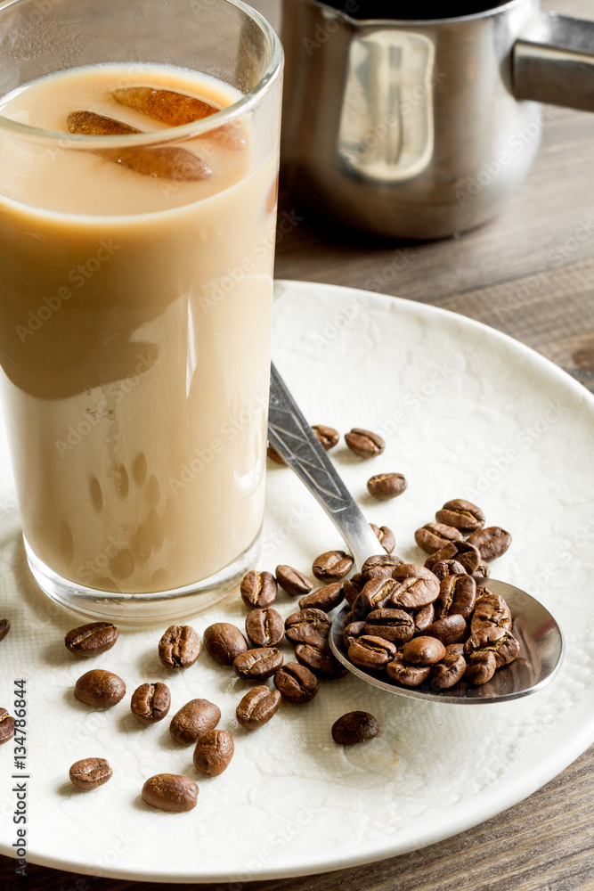 coffee with ice in glass on wooden background