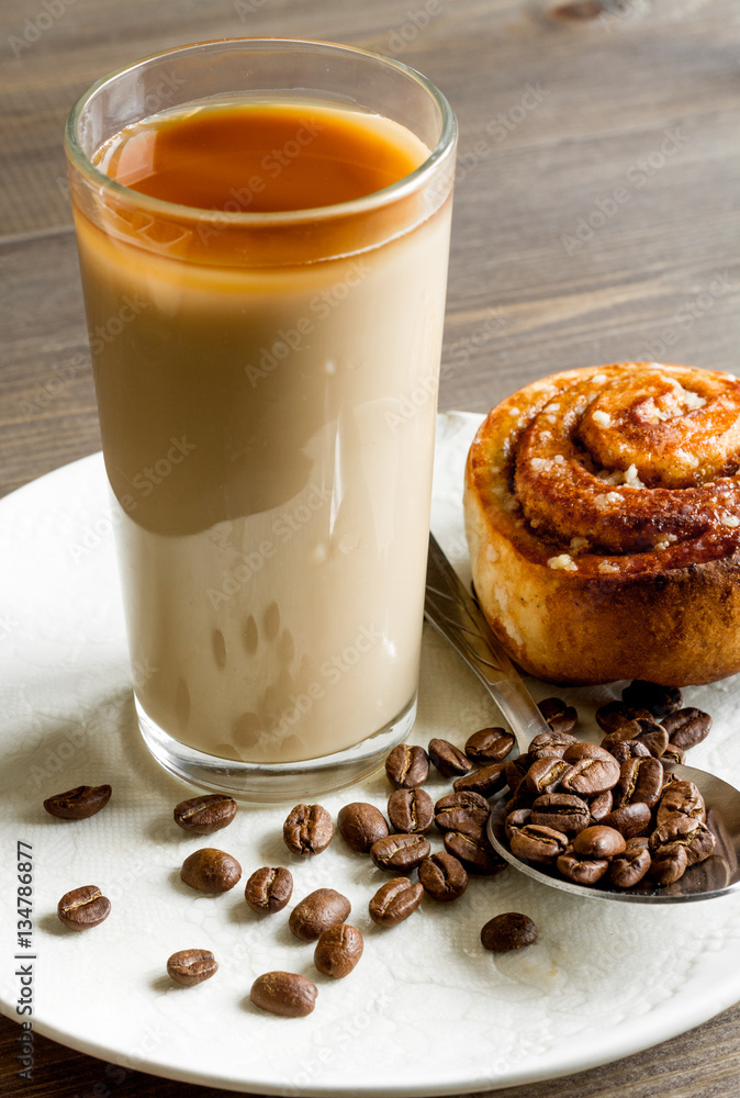 coffee with ice in glass on wooden background