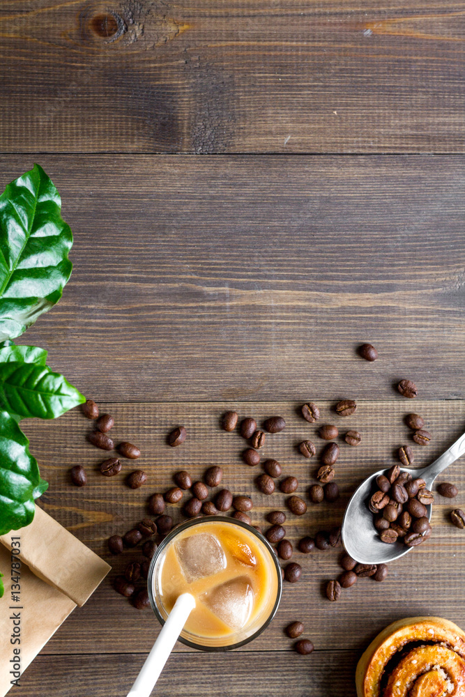 coffee with ice in glass on wooden background top view