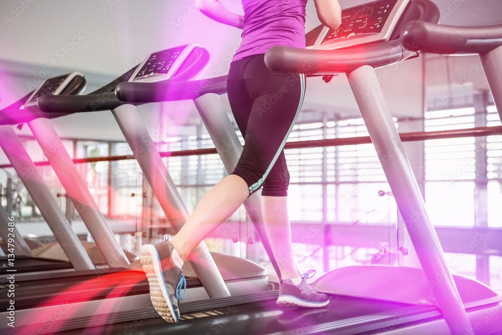 Lower section of fit woman on treadmill