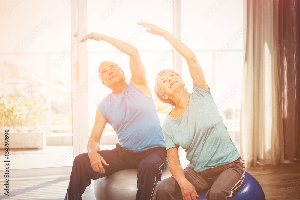 Senior couple exercising at home