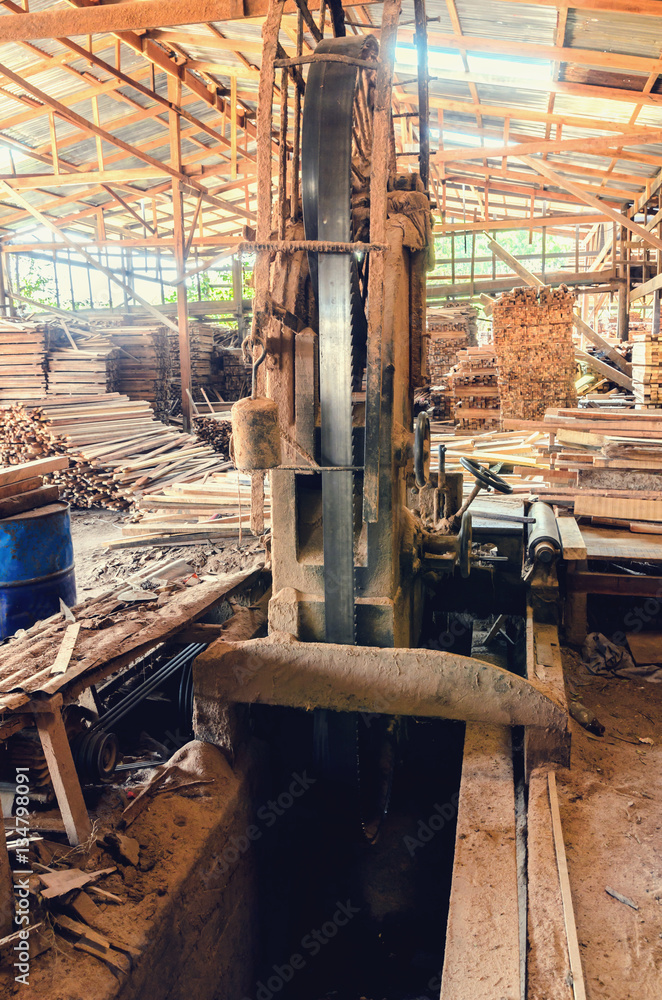 industrial wood production factory  band saw sawmill being used to cut  into dimension lumber