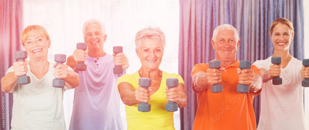 Portrait of seniors exercising with weights