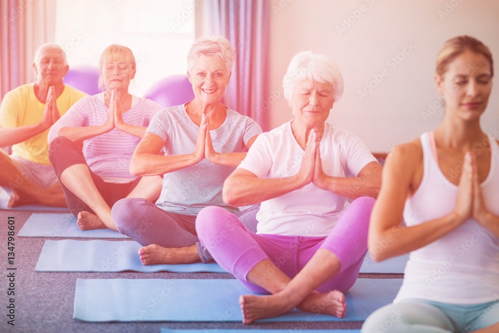 Instructor performing yoga with seniors