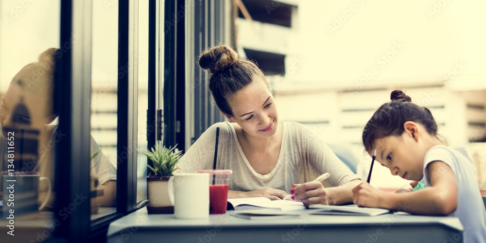 Woman And Girl Doing Homework Concept