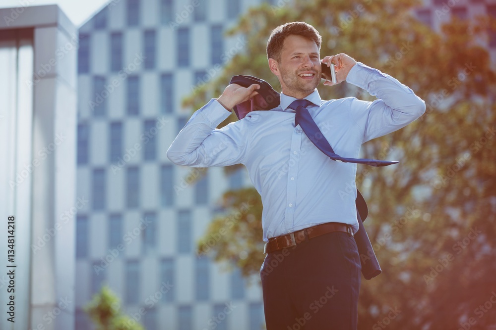 Happy businessman talking on mobile phone