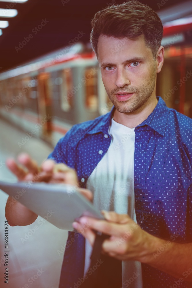 Portrait of handsome man using digital tablet 