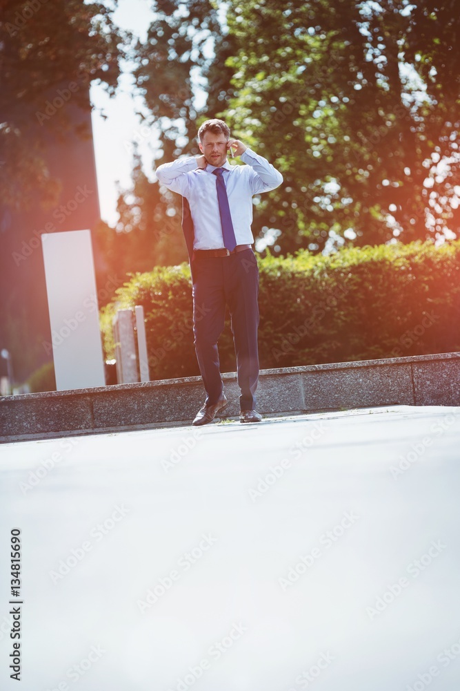 Full length of businessman talking on mobile phone