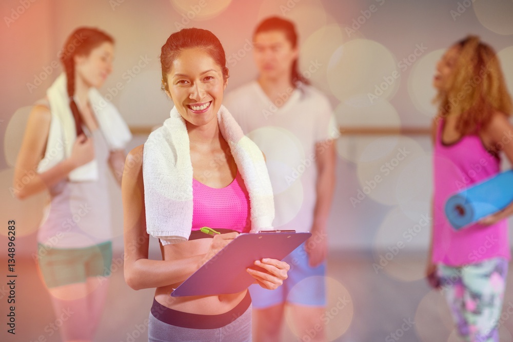 Portrait of female trainer holding clipboard