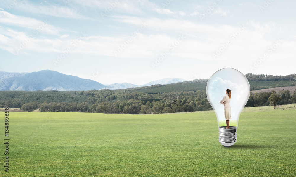 Businesswoman inside light bulb