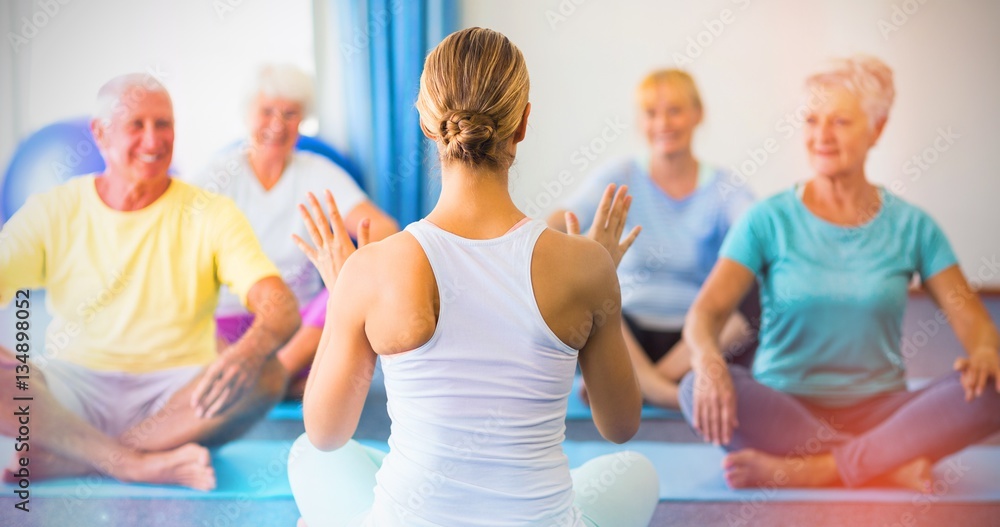 Instructor performing yoga with seniors