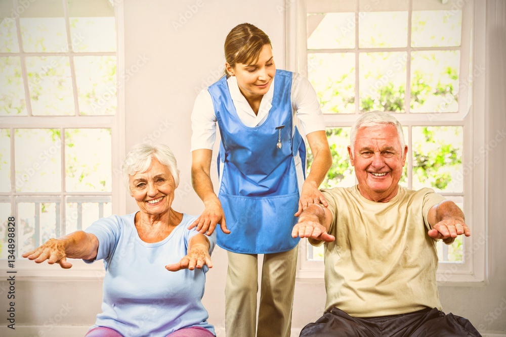 Nurse assisting senior man and woman