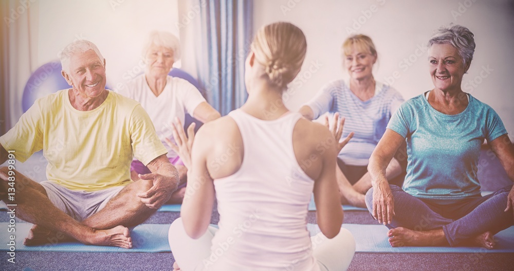 Instructor performing yoga with seniors