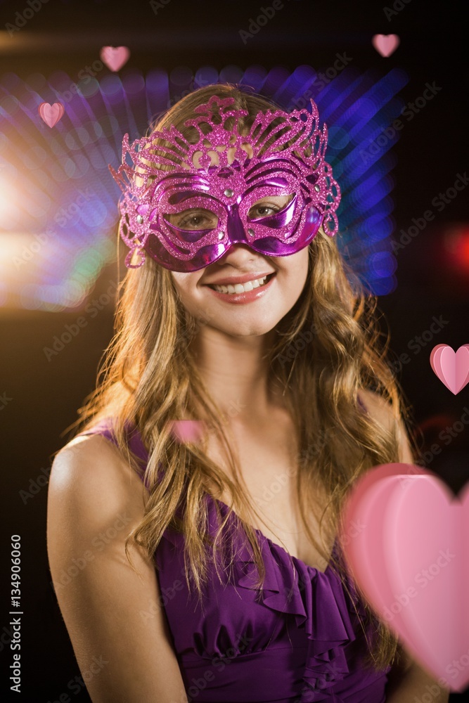 Composite image of woman wearing masquerade in bar