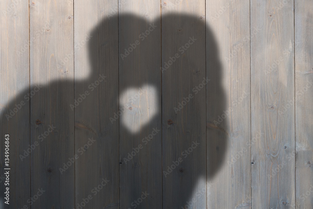 Composite image of man kissing woman on cheek